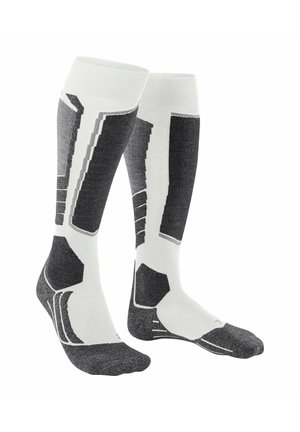 Calze compressive in bianco e grigio. Presentano motivi geometrici, texture a costine e zone rinforzate sulla punta e sul tallone per una maggiore durata.