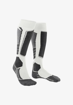 Calze compressive in bianco e grigio. Presentano motivi geometrici, texture a costine e zone rinforzate sulla punta e sul tallone per una maggiore durata.