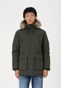 Olive green parka jacket with a fur-lined hood, zip closure, and two front pockets, made from a smooth, durable material.