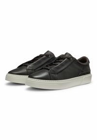 Black leather sneakers with a smooth texture, rounded toe, and contrasting white sole. Features laces and subtle stitching details.