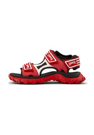 Red and black sandal with adjustable straps, open design, textured rubber sole, and Camper branding on straps and heel.