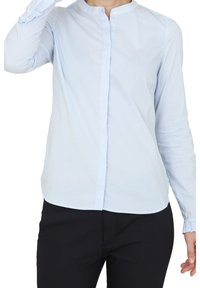 Light blue button-up shirt with white vertical stripes, round collar, and long sleeves with ruffled cuffs. Smooth cotton fabric.