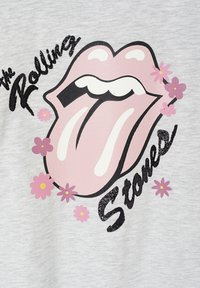 Gray fabric shirt featuring a large pink Rolling Stones logo with a tongue design, surrounded by small pink and purple flowers.