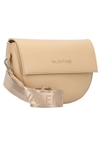 Béžová kožená kabelka přes rameno s kulatým tvarem, magnetickým zavíráním na klapku a texturovaným látkovým popruhem se vzorem opakujícího se nápisu „VALENTINO“.