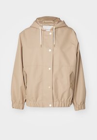 Beżowa, lekka kurtka z kapturem, z detalami w złotym kolorze, zapięciem na guziki z przodu oraz elastycznymi mankietami i dolnym brzegiem. Dwie boczne kieszenie.