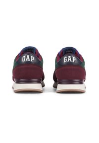 GAP sneakers featuring a burgundy suede base, green mesh accents, navy tongue, and prominent white logo on the heel. Rubber sole design.