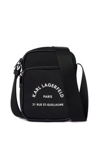 Black nylon crossbody bag with a zip closure, featuring white printed text: "KARL LAGERFELD PARIS 21 RUE ST-GUILLAUME." Adjustable strap.