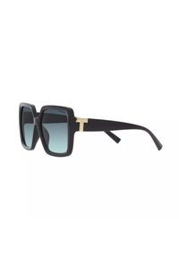 Occhiali da sole quadrati con montatura in nero opaco, lenti blu sfumate e un accento dorato sulle tempie. Texture liscia su tutta la superficie.