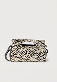 Ορθογώνια γυναικεία τσάντα με ασπρόμαυρο animal print με κηλίδες, χειρολαβή με κοψίματα και αποσπώμενο μαύρο ιμάντα ώμου σε λευκό φόντο.