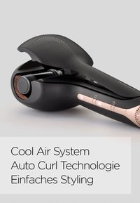 Black automatic curling tool with a sleek design, textured grip, copper accents, digital display, and buttons for temperature control.