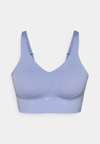 Vaalean lilas urheiluliivit, joissa on sileä pinta, syvä V-aukko, leveät hihnat ja valkoinen Nike-logo. Edessä verkkomaisia yksityiskohtia.