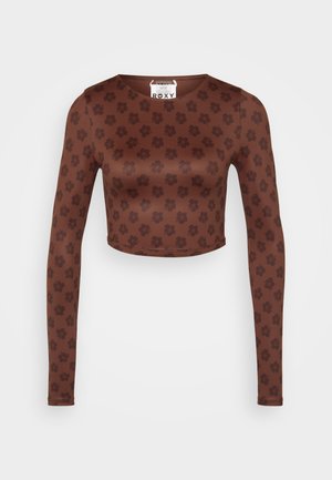 Brown long-sleeve crop top with a floral pattern, made of smooth fabric, features a round neckline and fitted silhouette. Roxy label inside.