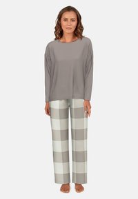 Grey long-sleeve top with a round neckline paired with light grey and beige checkered pajama pants. Soft fabric and relaxed fit.