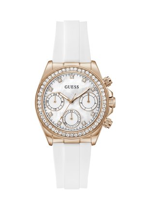 Ρολόι Guess με λευκό λουράκι σιλικόνης, κάσα σε ροζ χρυσό, στεφάνι με κρύσταλλα, λευκό καντράν, τρεις υποκαντράν και δείκτες ώρας με κρύσταλλα.