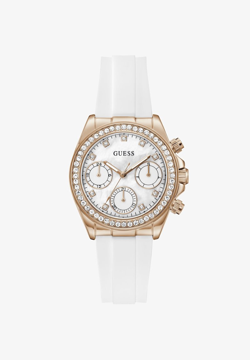 Ρολόι Guess με λευκό λουράκι σιλικόνης, κάσα σε ροζ χρυσό, στεφάνι με κρύσταλλα, λευκό καντράν, τρεις υποκαντράν και δείκτες ώρας με κρύσταλλα.