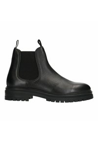 Bottines Chelsea en cuir noir avec panneaux élastiques sur les côtés, languettes de tirage, finition texturée et semelle en caoutchouc noir robuste avec motifs.