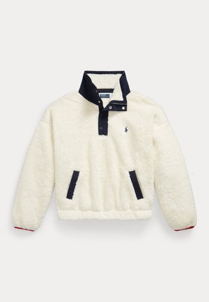 Beżowy polarowy sweter z granatowymi zatrzaskami, kołnierzem, wykończeniem kieszeni oraz małym haftowanym logo na piersi.