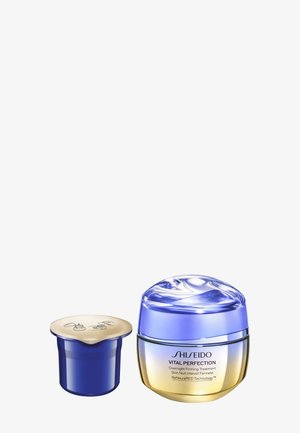Shiseido Vital Perfection crème in een ronde verpakking met een glanzend blauwe deksel en een gouden basis. Inclusief een klein blauw en gouden potje.
