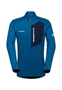 Veste zippée bleue en tissu texturé, avec un panneau bleu marine et une poche poitrine zippée avec une bordure blanche. Logo de la marque à l'avant.