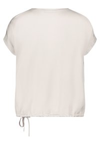 Haut beige clair à manches courtes avec encolure ronde et ourlet ajustable par cordon, montré de dos sur un fond uni.