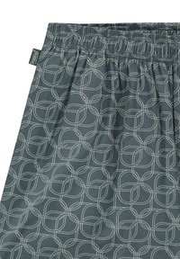 Fustă din țesătură gri cu un model geometric format din cercuri interconectate într-o nuanță mai deschisă. Are un braț elastic pentru confort.