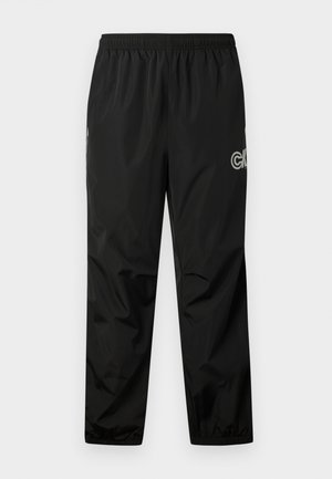 Pantaloni da pioggia neri realizzati in materiale leggero e impermeabile. Presentano una vita elasticizzata e un dettaglio con logo di lato. Texture liscia.
