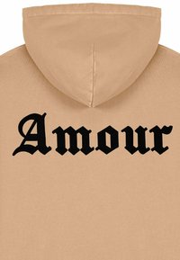 Felpa beige con un grande e audace testo nero "Amour" sulla schiena. Tessuto dalla trama liscia, cappuccio standard e senza ulteriori decorazioni.