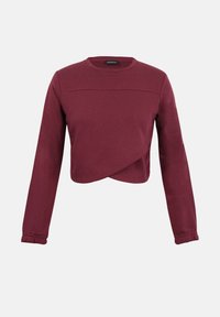 Pull court bordeaux à manches longues avec un col rond et un détail asymétrique à l’ourlet.