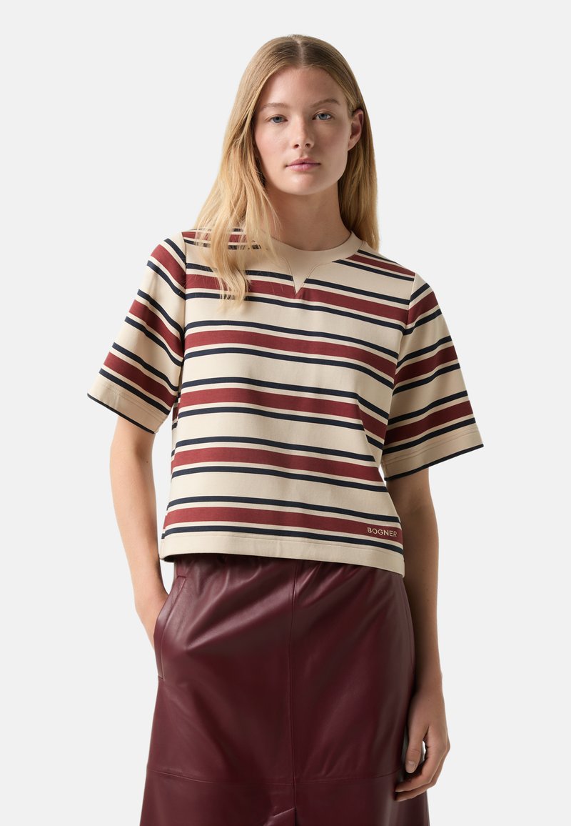 Beige short-sleeve top with horizontal stripes in maroon, navy, and cream. Features a round neckline and a relaxed fit. Brand label visible.