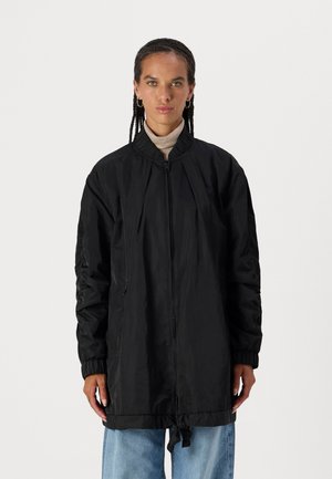 Schwarze Nylon-Bomberjacke mit Reißverschluss, geripptem Kragen und elastischen Bündchen. Verfügt über einen Kordelzugsaum und Seitentaschen.