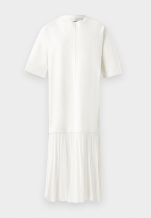 White dress with short sleeves, a round neckline, and a textured top. The lower half features a pleated design with a soft, flowing fabric.