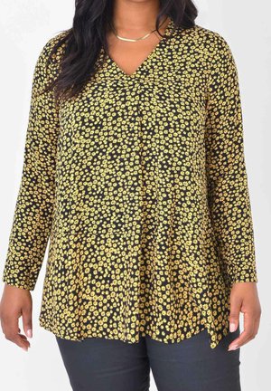 Schwarzes langärmeliges Oberteil mit kleinem gelbem Blumenmuster, V-Ausschnitt und ausgestelltem Design. Weicher Stoff mit entspannter Passform.