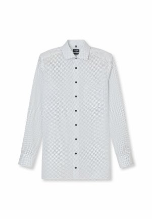Chemise blanche à manches longues avec des pois noirs, col boutonné et poche poitrine. Dispose de boutons noirs sur le devant. Texture de tissu lisse.