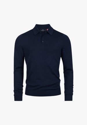 Marineblå strikket polo skjorte med klassisk krage, to knapper og lange ermer. Myk tekstur, tettsittende design og ribbede mansjetter.