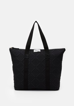 Black quilted tote bag with diagonal diamond pattern, dual black fabric handles, and a top zipper closure. Features a label on front.