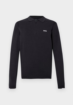 Black long-sleeve polo shirt made of knit fabric. Features a half-zip collar, slim fit, and a small white logo on the chest.