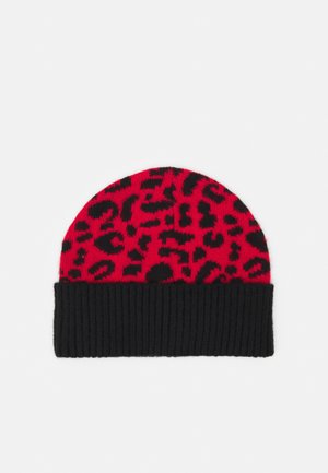 Red knit beanie with black leopard print pattern and a solid black ribbed cuff at the bottom.