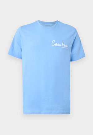 Light blue short-sleeve crew neck t-shirt with small white "Calvin Klein Established 1968" logo on the left chest.