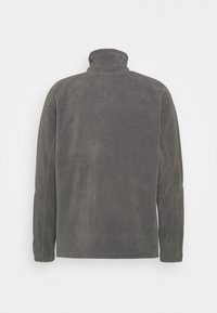 Hallhallane fliisist kootud pullover kõrge krae, pikkade varrukate ja elastsete mansettidega. Omab sujuvat tekstuuri ja ühtlast värvi kogu ulatuses.