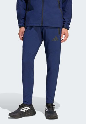 TIRO TRAVEL  - Tracksuit bottoms - team navy blue/black