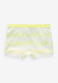 Boxer shorts bianchi con un motivo ondulato di un giallo chiaro. Tessuto morbido con una vita elastica su cui è impresso il nome del marchio.