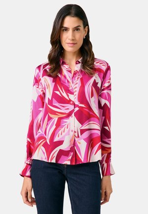 Long-sleeve button-up shirt featuring a vibrant pink floral pattern, made of smooth fabric. Includes cuffs and a classic collar.