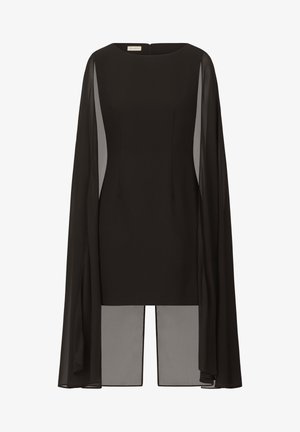 Haut noir avec un design structuré, des manches longues en voile et un col haut. Fermeture dans le dos avec un détail fendu à l'ourlet.