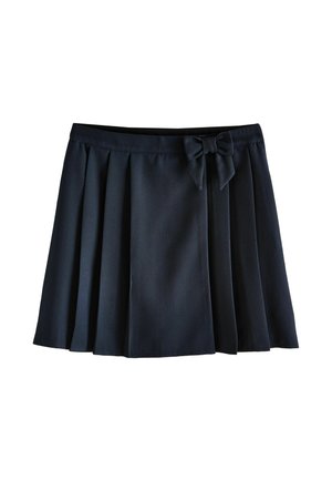 Tessuto blu navy scuro con cerniera parzialmente aperta e dettaglio decorativo a fiocco di stoffa vicino alla cucitura.