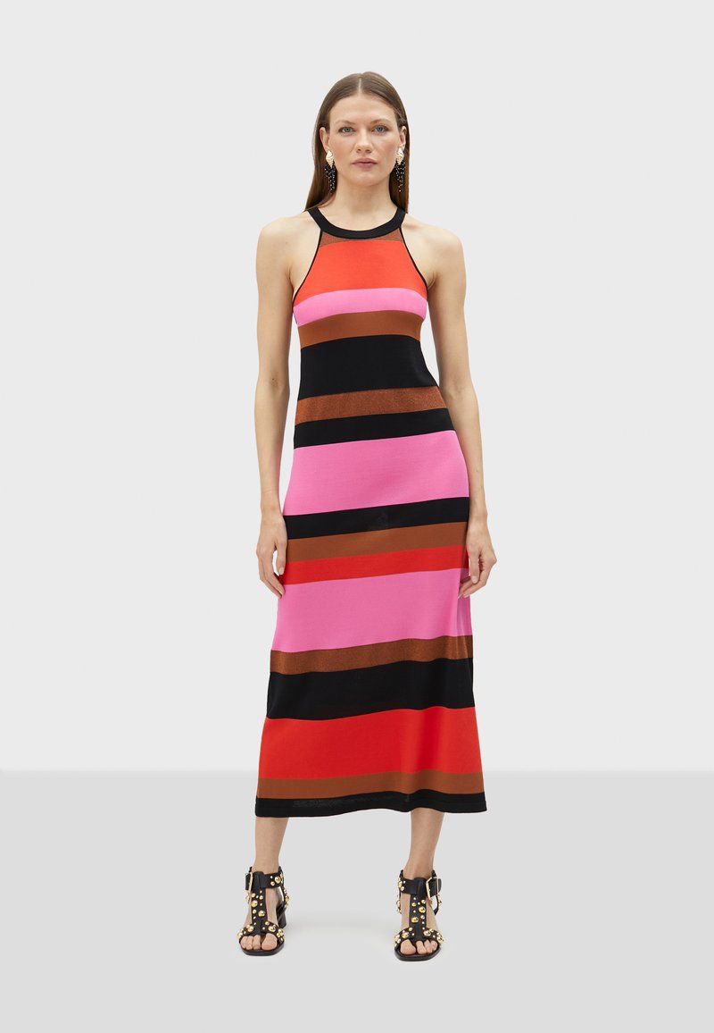 Striped maxi dress in red, pink, brown, and black. Features a fitted bodice with a halter neckline and a straight silhouette, made of stretch fabric.