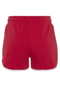 Red cotton shorts with an elastic waistband, featuring a simple design, and white trim along the hem. Smooth texture, casual style.