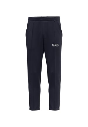 Donkerblauwe sportbroek met rechte pijpen, zijzakken en een wit JAKO-logo op de rechterdij.