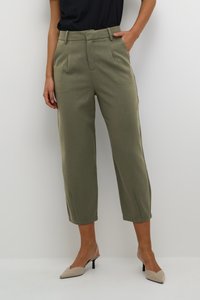 Pantalons taillés vert olive avec poches latérales, plis et longueur raccourcie. Texture lisse, dotée d'une taille classique et de lignes épurées.