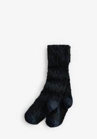 Calcetines negros con patrón de diamante texturizado, puño acanalado y punta suave. Hechos de tejido suave, con acentos oscuros contrastantes.