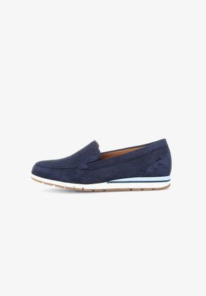 Navy blue suede slip-on shoe with a low heel, featuring white and light blue accents on the sole, and a classic moccasin stitch design.